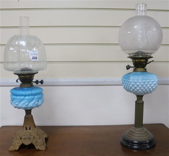 Two oil lamps with blue glass fonts